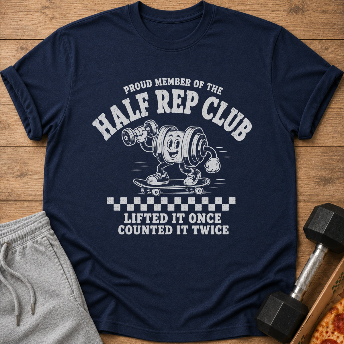 Navy t-shirt with "Proud Member of the Half Rep Club" and cartoon weightlifting barbell on skateboard.