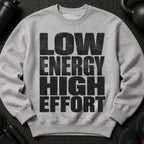 Grey crewneck sweatshirt with black distressed text reading "LOW ENERGY HIGH EFFORT".
