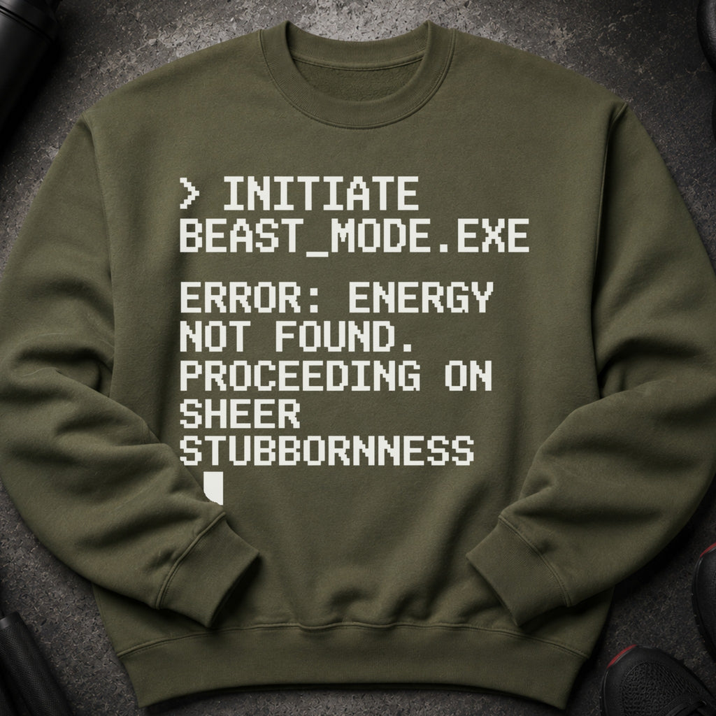 Olive green sweatshirt with white pixelated text: "> INITIATE BEAST_MODE.EXE ERROR: ENERGY NOT FOUND. PROCEEDING ON SHEER STUBBORNNESS."