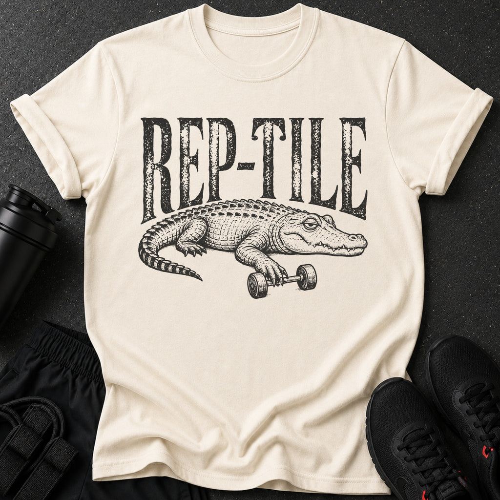 Cream t-shirt with black "REP-TILE" text and alligator lifting dumbbell graphic.