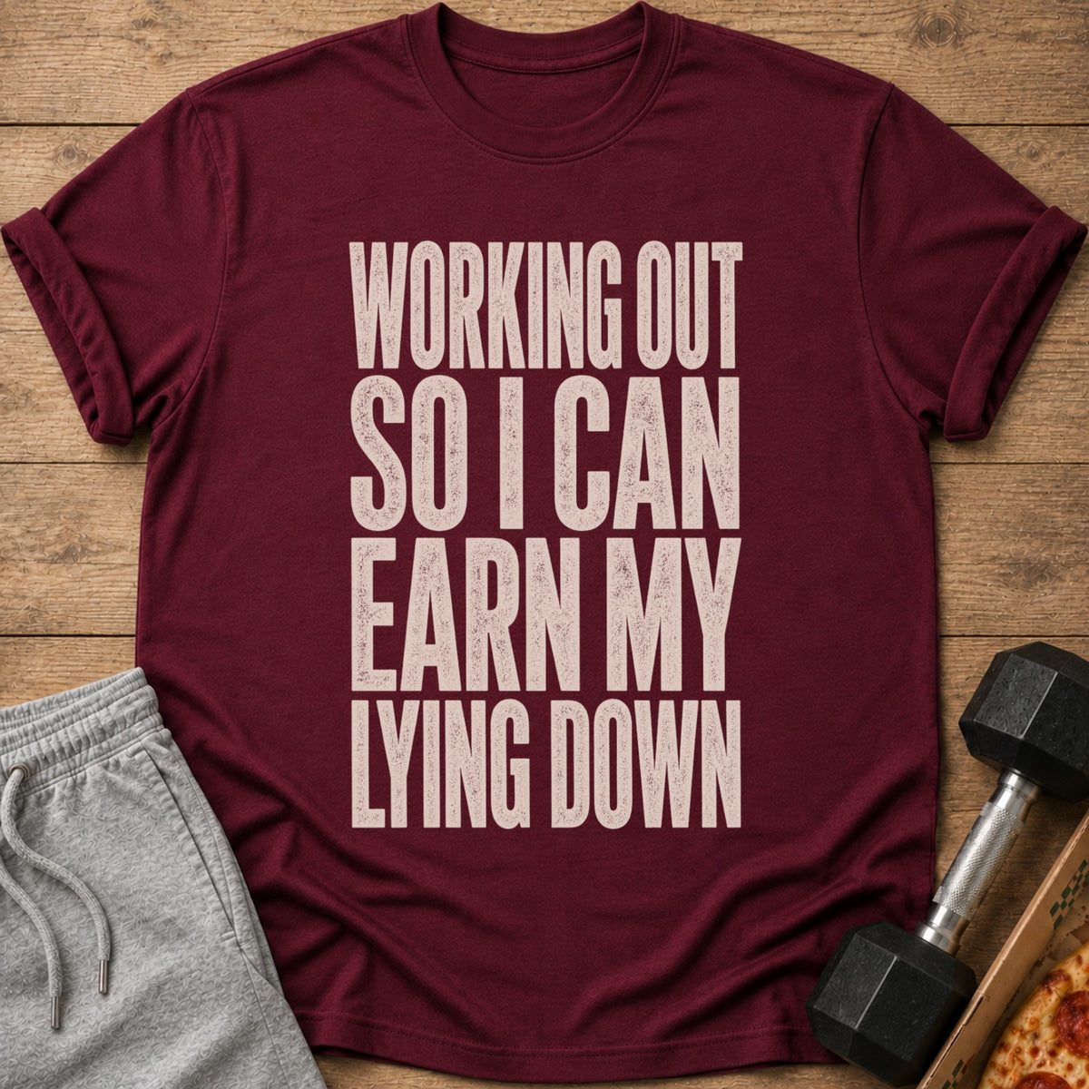 Maroon t-shirt with text "WORKING OUT SO I CAN EARN MY LYING DOWN".