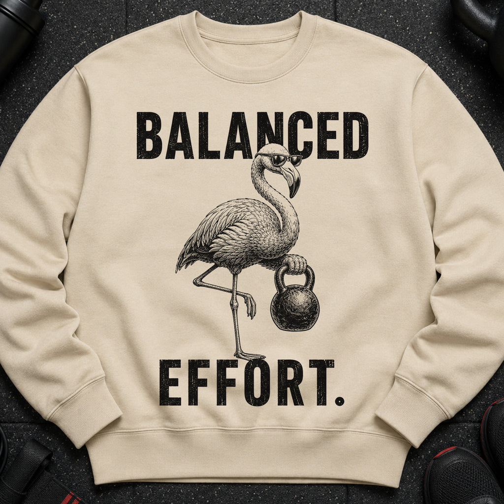 Cream sweatshirt with a flamingo holding a kettlebell and text "BALANCED EFFORT."
