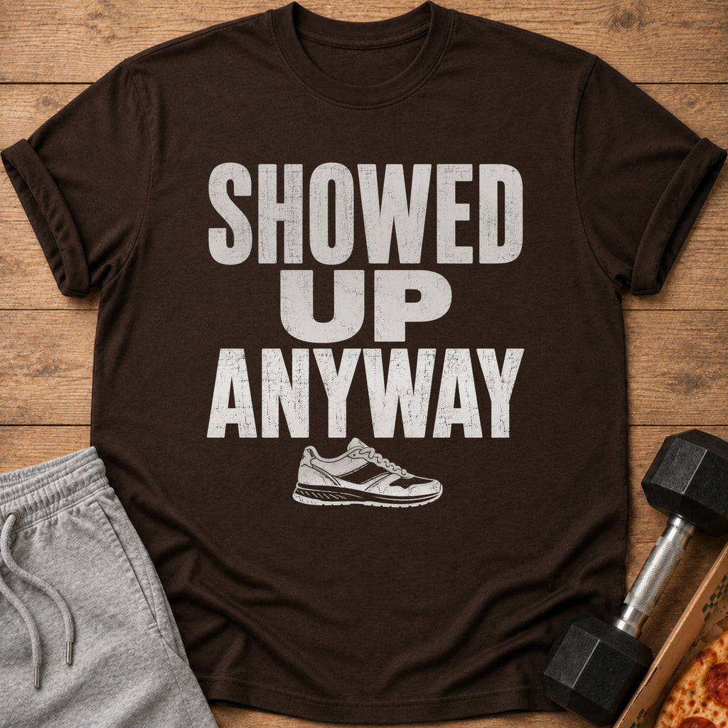 Brown t-shirt with distressed white text "SHOWED UP ANYWAY" and a sneaker graphic.