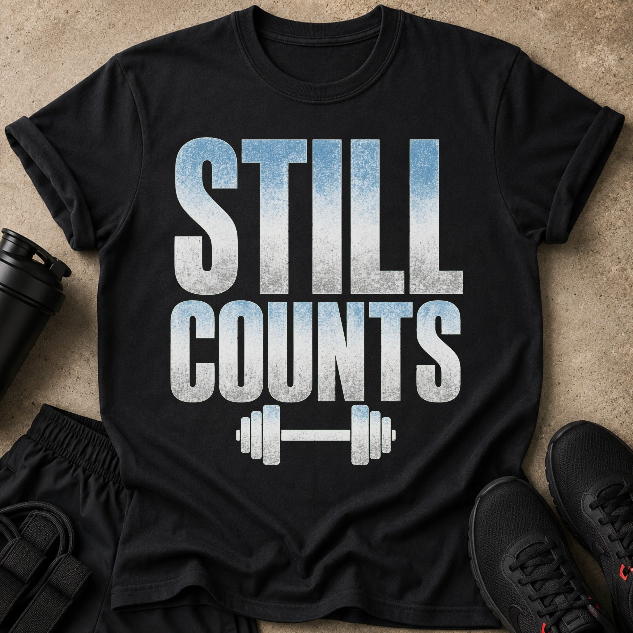 Black t-shirt with "STILL COUNTS" text and dumbbell graphic.