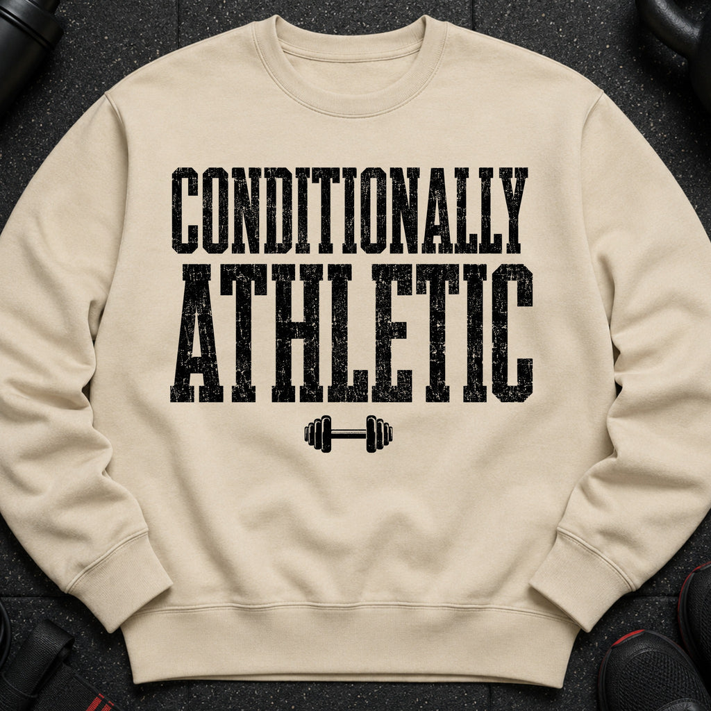 Light beige crewneck sweatshirt with black distressed text "CONDITIONALLY ATHLETIC" and dumbbell graphic.