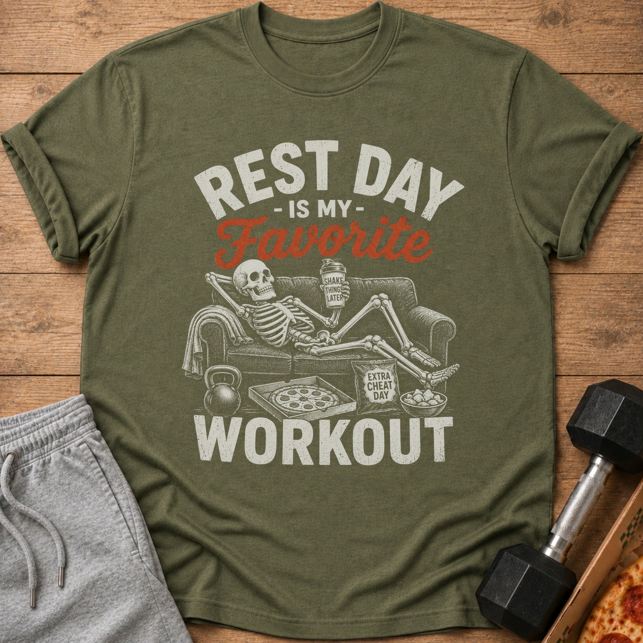 Olive t-shirt with skeleton on couch, pizza, and dumbbell, reading "Rest Day is My Favorite Workout."