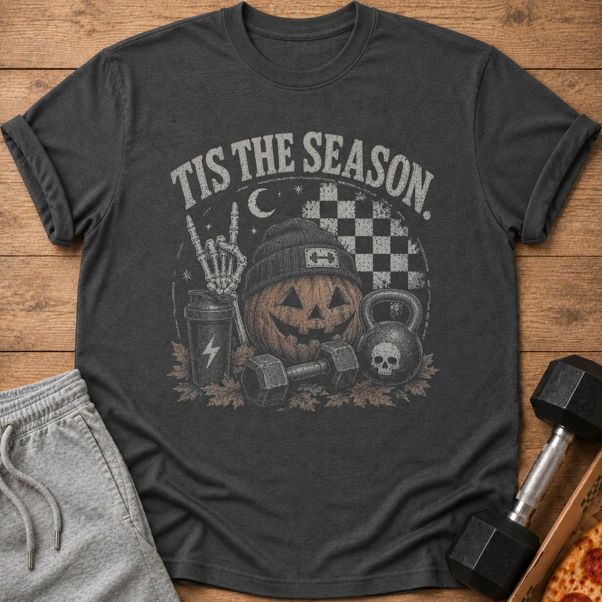Dark grey t-shirt with a vintage graphic of a pumpkin, weights, and skeleton hand.