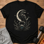 Black t-shirt with a raven perched on a kettlebell under a crescent moon.