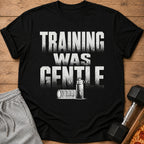 Black t-shirt with text "TRAINING WAS GENTLE", water bottle, and foam roller graphic.