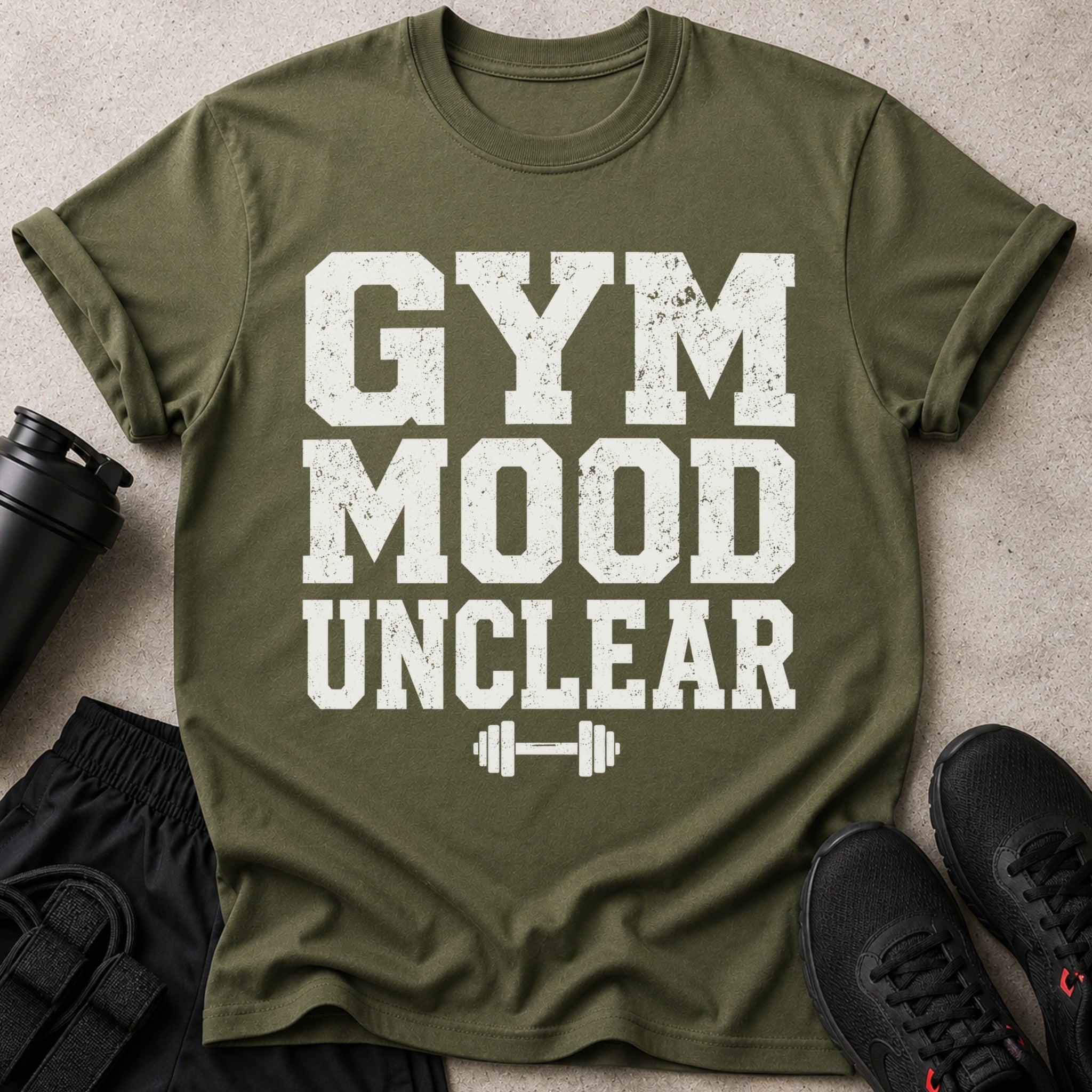 Olive green t-shirt with distressed white text "GYM MOOD UNCLEAR" above a dumbbell graphic.