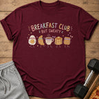 Maroon t-shirt with "Breakfast Club But Sweaty" text and cartoon breakfast foods.