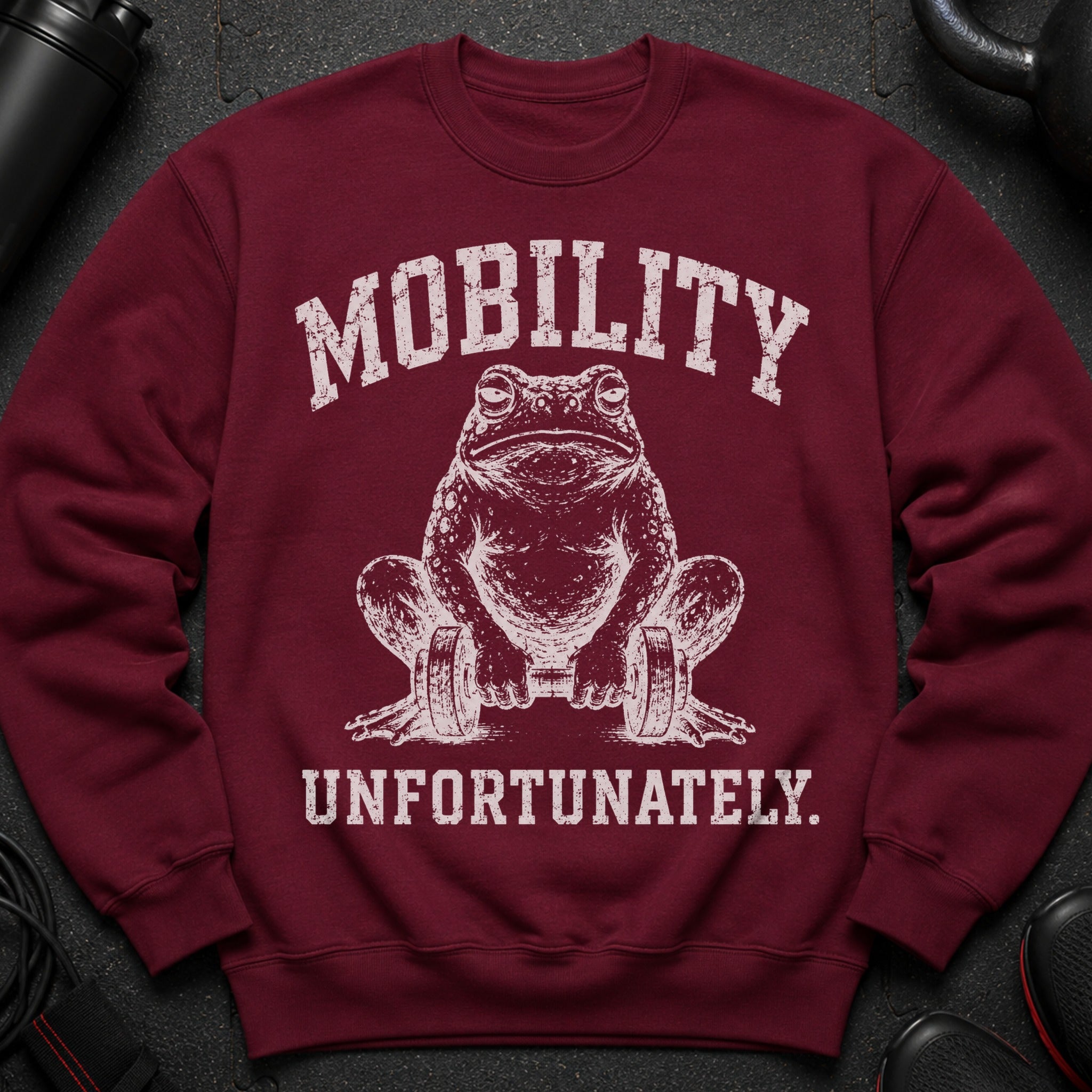 Maroon sweatshirt with white text and distressed frog lifting dumbbells.