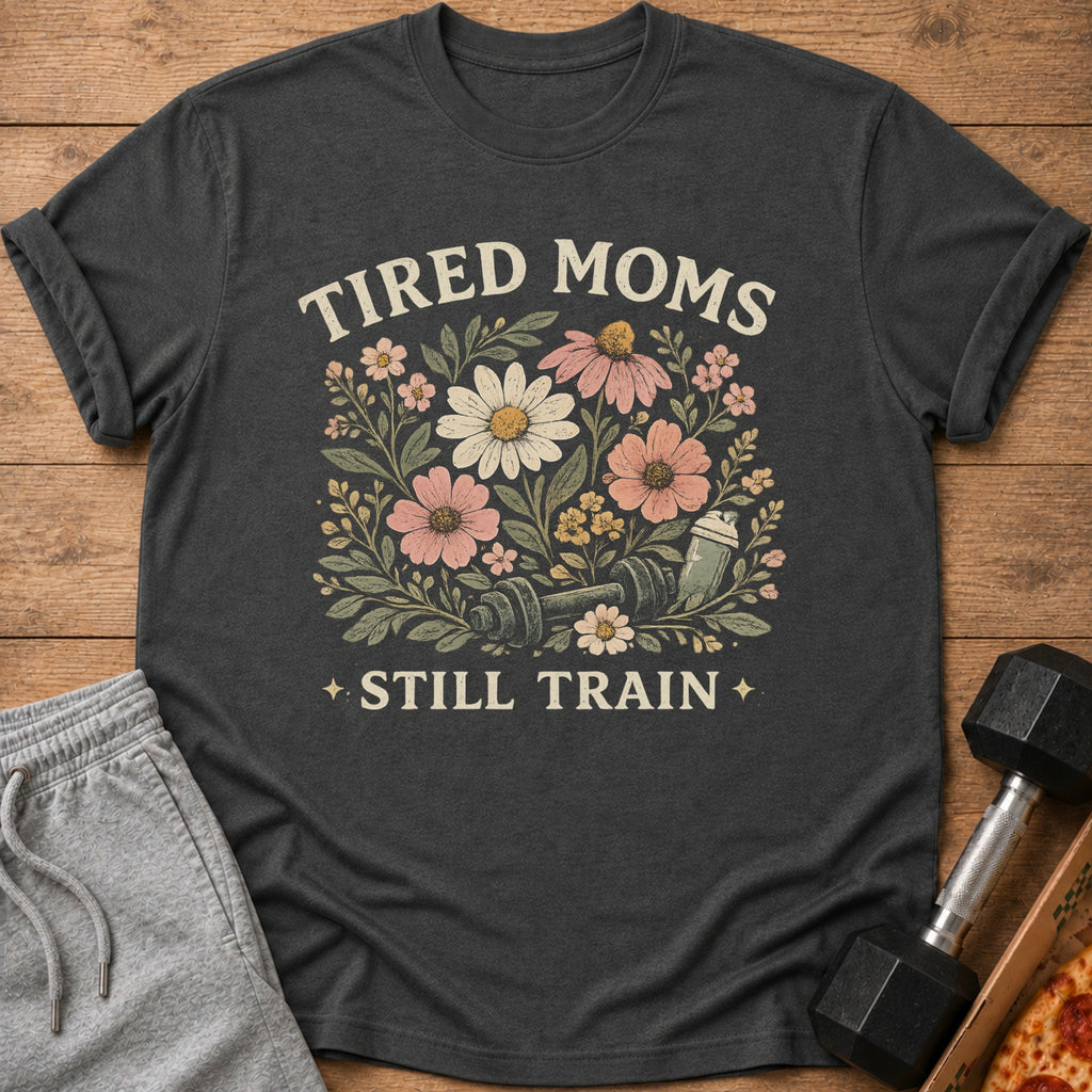 T-shirt with floral design, dumbbell, shaker bottle, and text "TIRED MOMS STILL TRAIN".