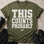 Olive green t-shirt with white text "THIS COUNTS PROBABLY" and a checkmark.