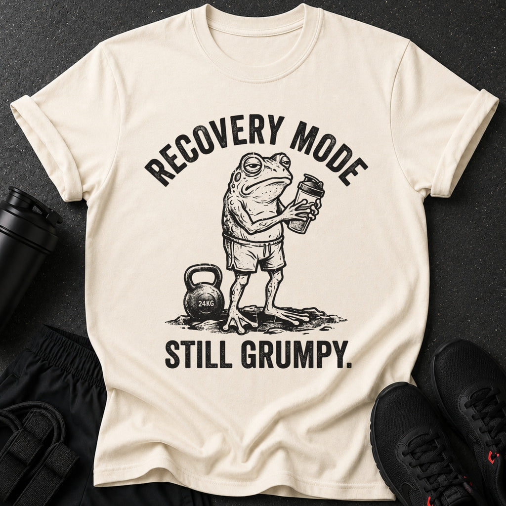 Cream t-shirt with a grumpy frog holding a shaker and text "Recovery Mode Still Grumpy."