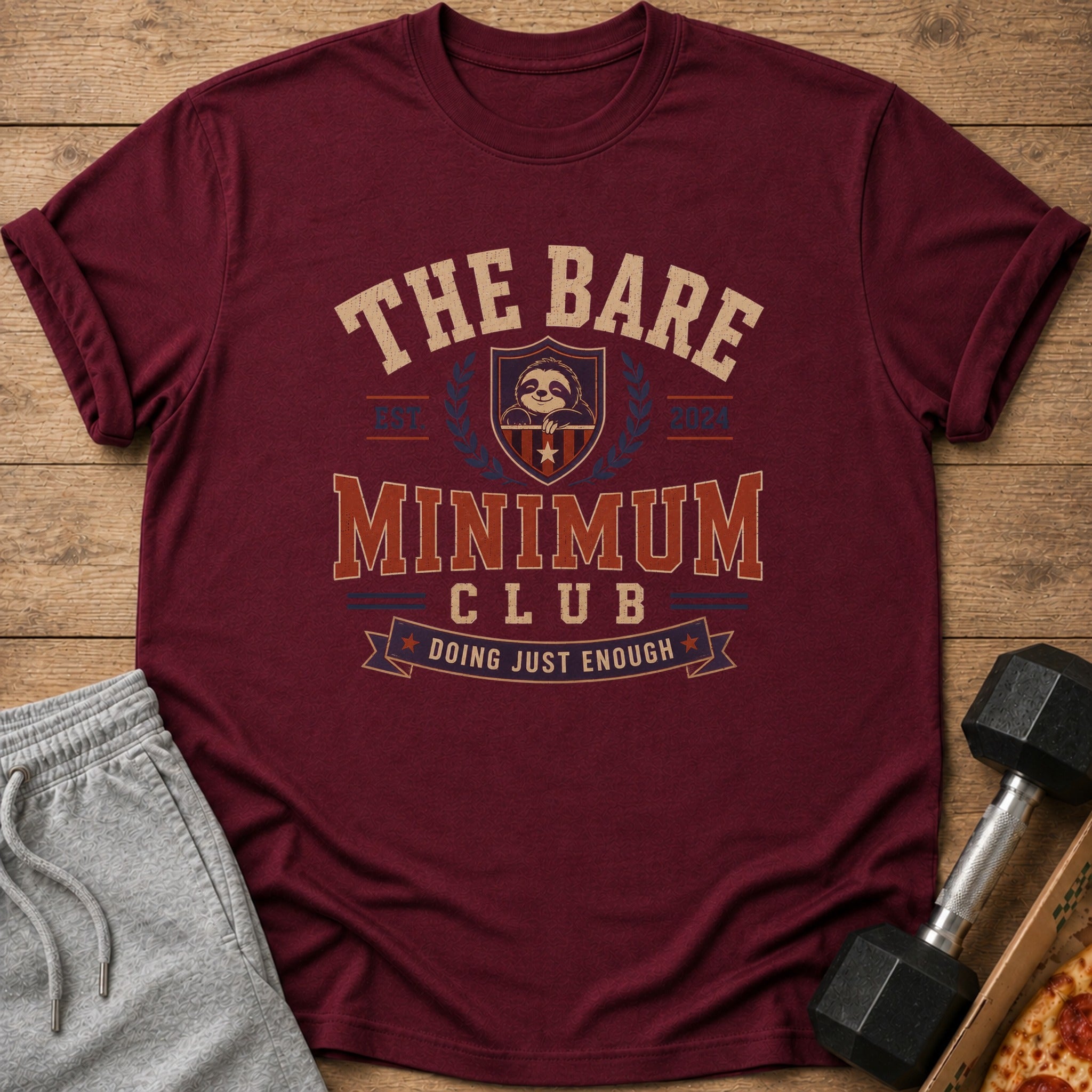 Maroon t-shirt with "The Bare Minimum Club Doing Just Enough" text and sloth graphic.