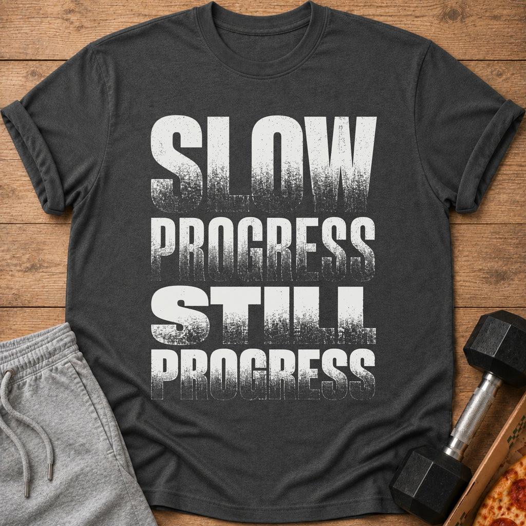 Dark gray t-shirt with white text reading "SLOW PROGRESS STILL PROGRESS".