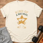 Cream t-shirt with cartoon star wearing sunglasses and text "Kind of a Big Deal".