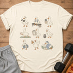 T-shirt with cartoon ducks exercising, holding weights, pizza, and resting.
