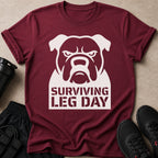 Maroon t-shirt with a white bulldog graphic and "SURVIVING LEG DAY" text.