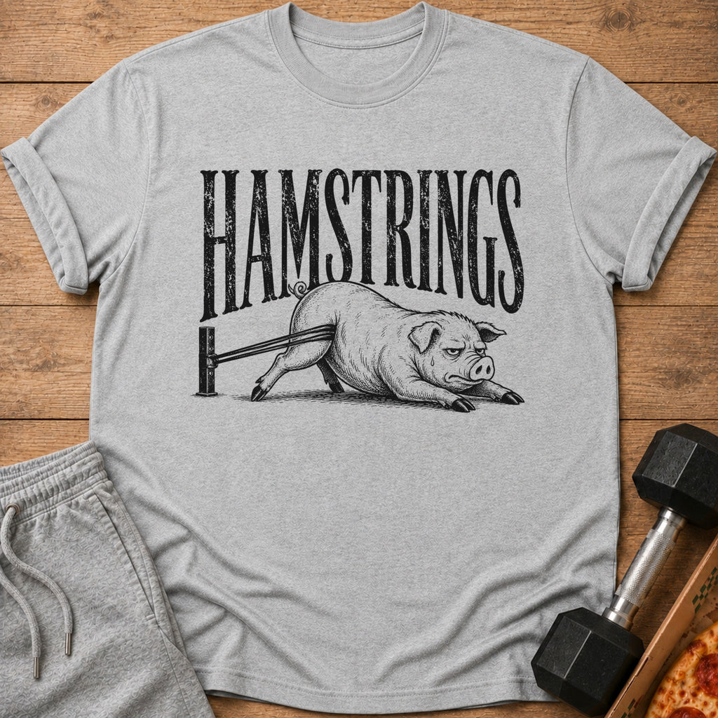Grey t-shirt with black text "HAMSTRINGS" and a pig exercising with resistance bands.