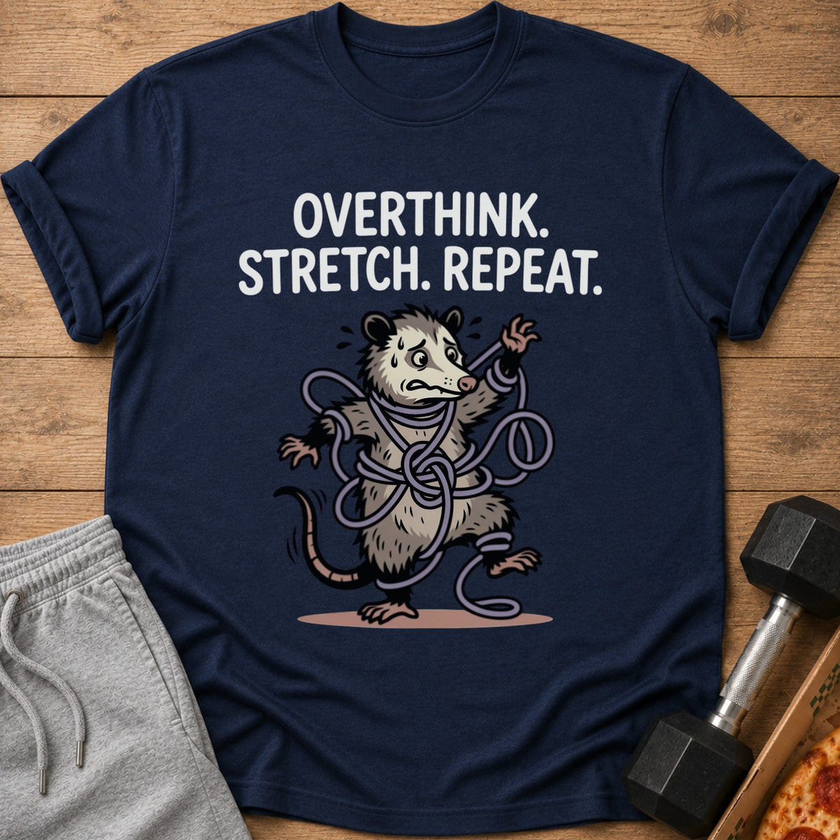 Navy t-shirt with text "Overthink. Stretch. Repeat." and a possum tangled in a rope.