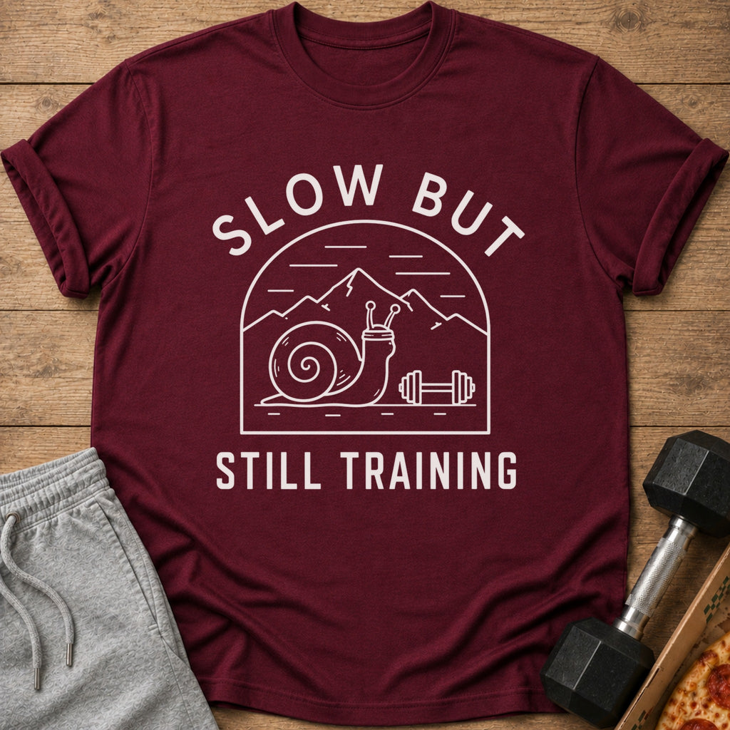 Maroon t-shirt with "SLOW BUT STILL TRAINING" text and snail graphic.