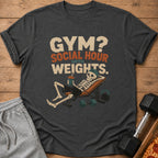 Dark t-shirt with text "GYM? SOCIAL HOUR WITH WEIGHTS." and a skeleton on a bench.