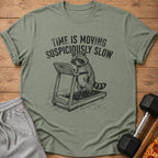 T-shirt with raccoon on treadmill, text "TIME IS MOVING SUSPICIOUSLY SLOW".