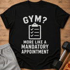 Black t-shirt with "GYM? More Like A Mandatory Appointment" text and checklist graphic.