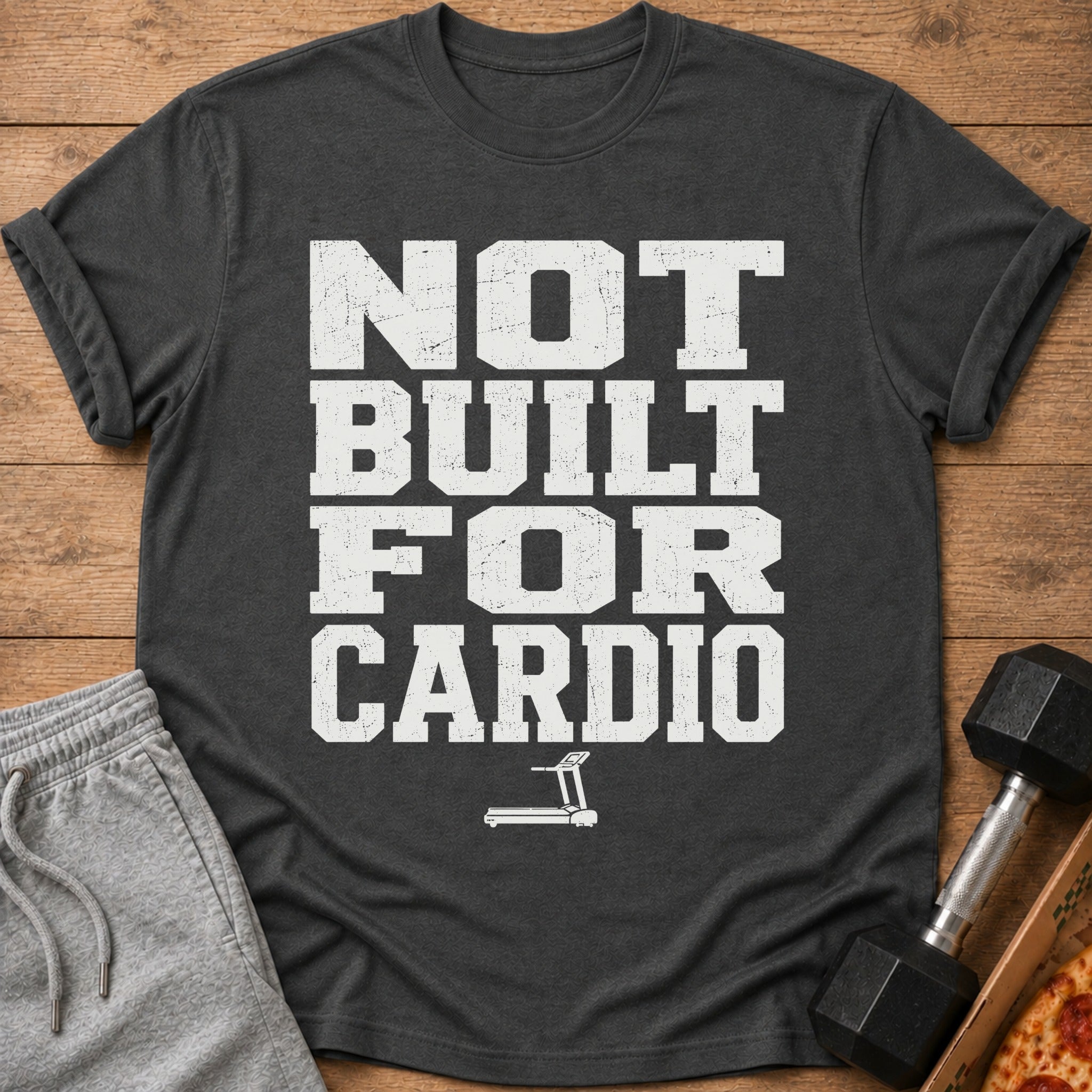 Dark grey t-shirt with distressed white text "NOT BUILT FOR CARDIO" and a treadmill icon.