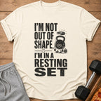 Cream t-shirt with black text reading "I'm not out of shape, I'm in a resting set"