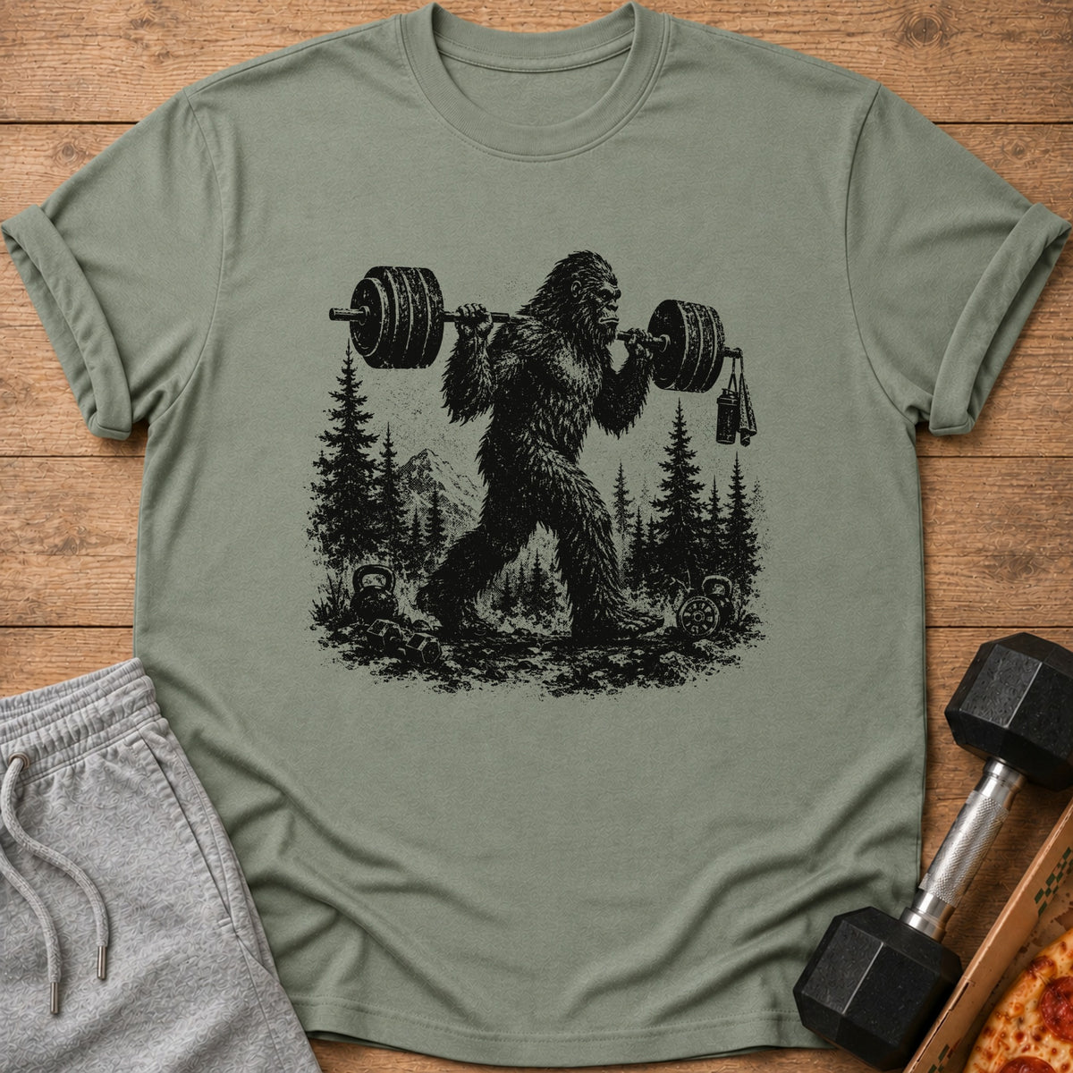 Bigfoot lifting a barbell in a forest with mountains and kettlebells.
