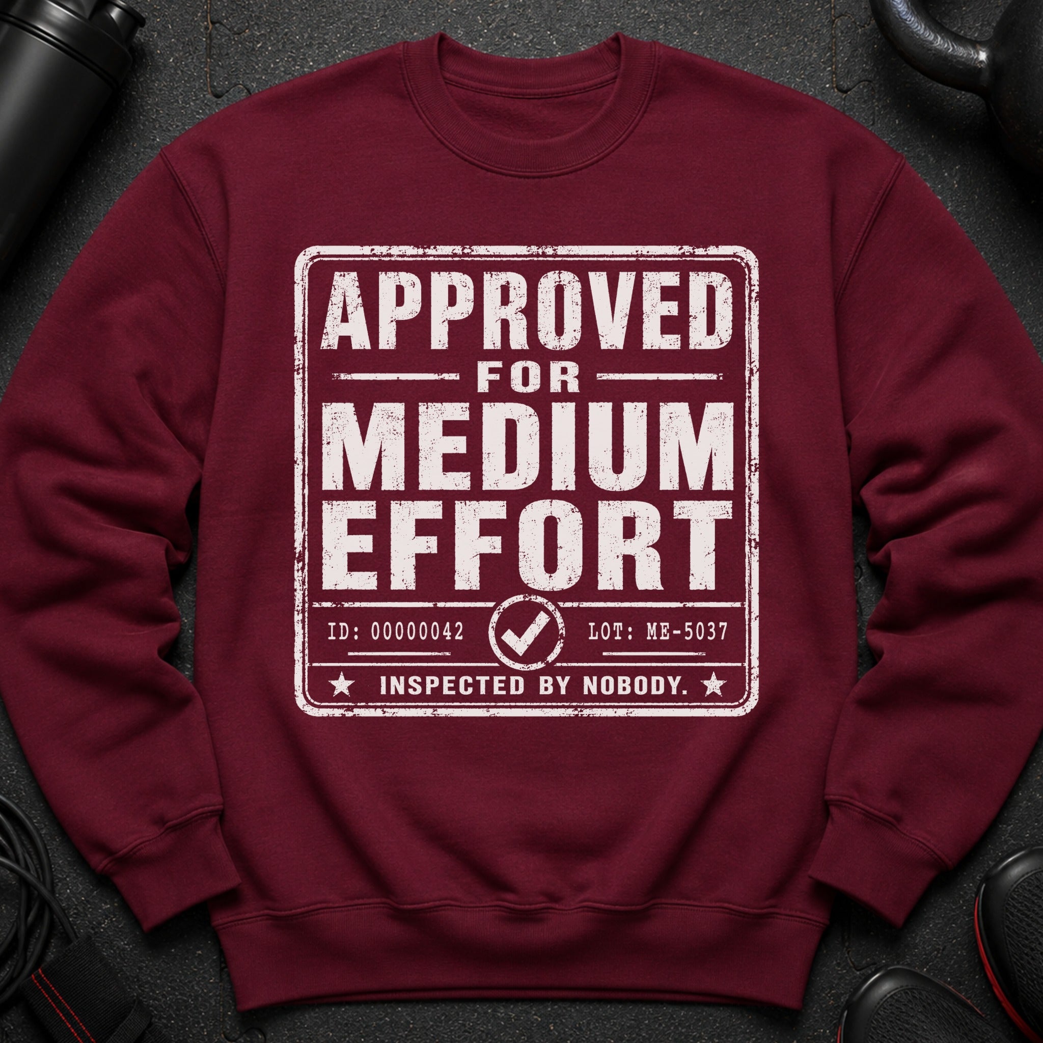 Maroon sweatshirt with "APPROVED FOR MEDIUM EFFORT INSPECTED BY NOBODY" text.
