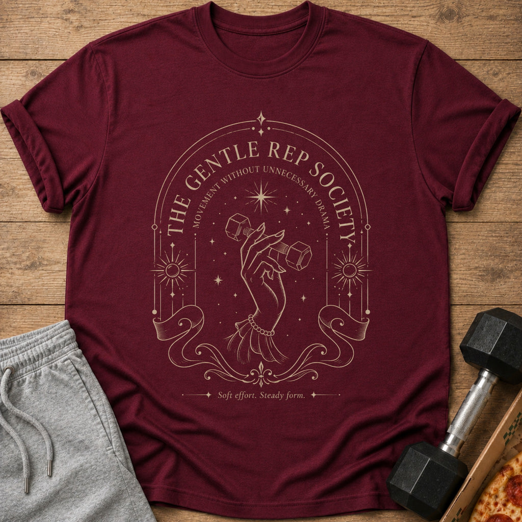 Maroon t-shirt with gold art depicting a hand holding a dumbbell and text.