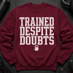 Maroon sweatshirt with "TRAINED DESPITE DOUBTS" text and kettlebell graphic.