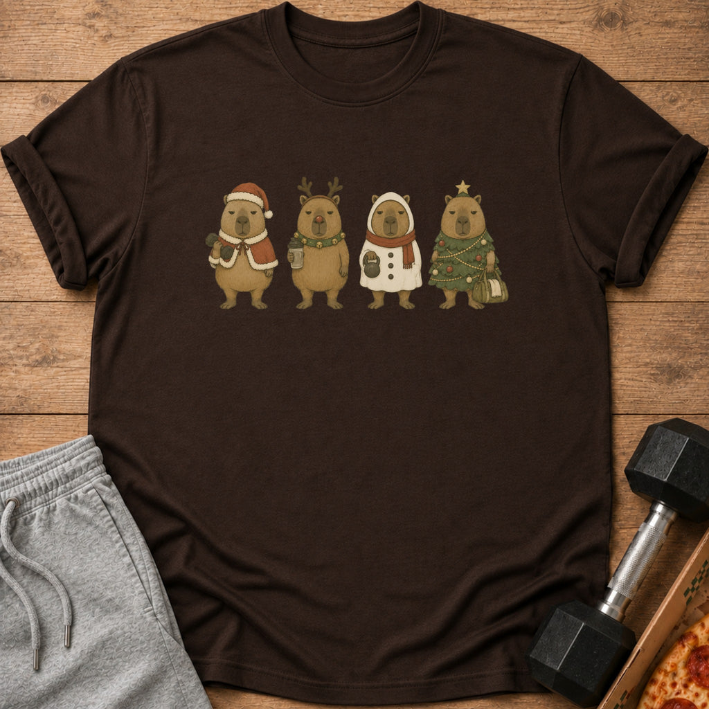 Four capybaras in festive Christmas outfits standing on a brown t-shirt.