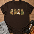 Four capybaras in festive Christmas outfits standing on a brown t-shirt.