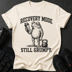 T-shirt with grumpy frog, shaker, and kettlebell. Text reads "RECOVERY MODE STILL GRUMPY."
