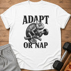 White t-shirt with graphic of chameleon lifting dumbbell and text "ADAPT OR NAP".