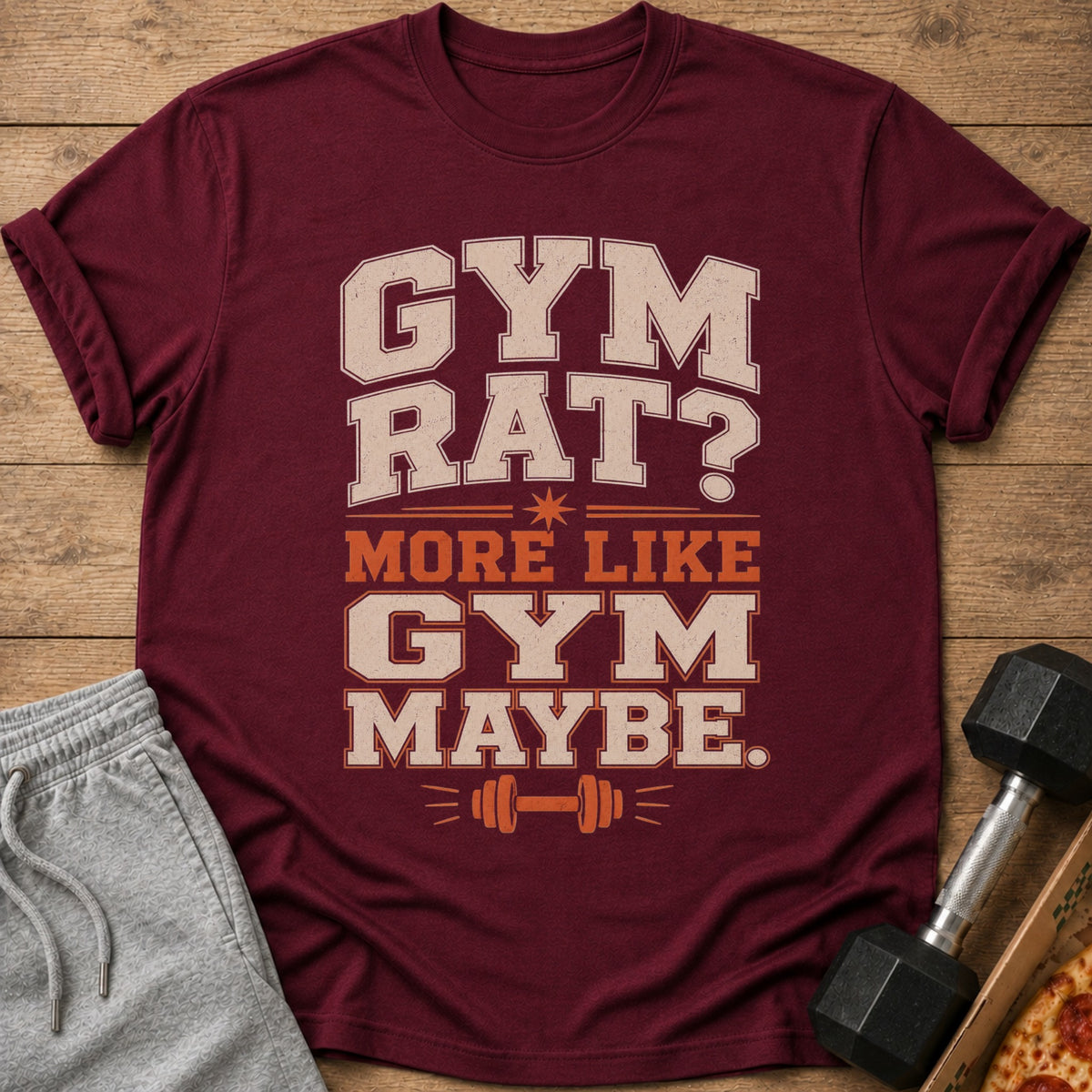 Maroon t-shirt with "Gym Rat? More Like Gym Maybe." text and barbell graphic.