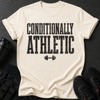 Cream t-shirt with black distressed text "CONDITIONALLY ATHLETIC" and a dumbbell graphic.