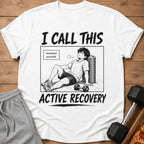White t-shirt with "I CALL THIS ACTIVE RECOVERY" and a comic illustration of a tired man.