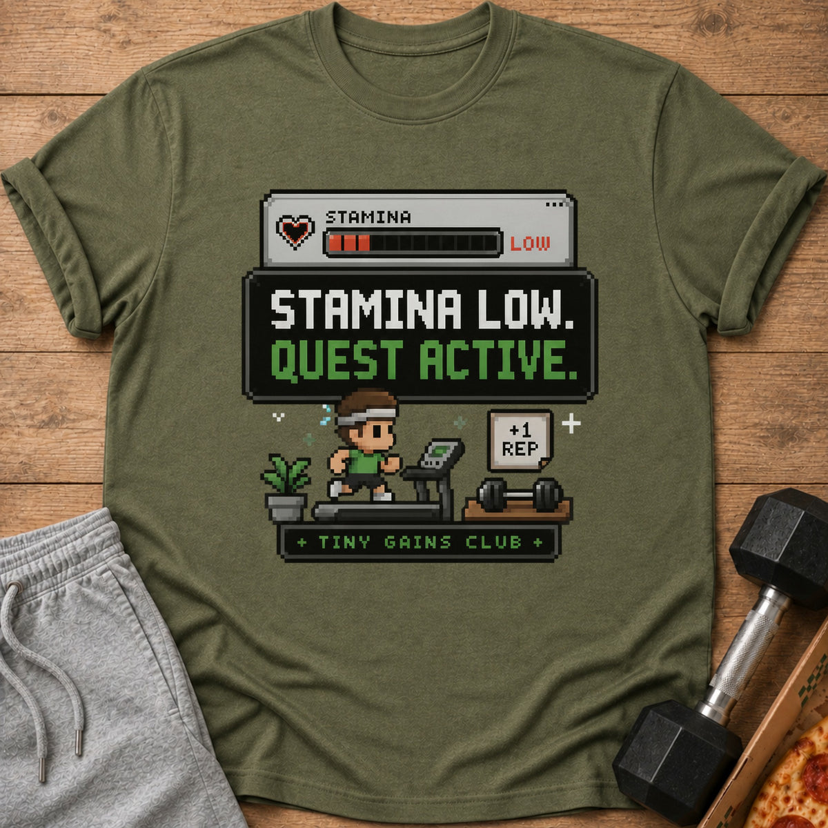 Green t-shirt with pixelated "Stamina Low. Quest Active. +1 Rep." graphic.