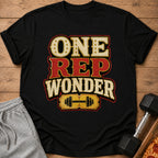 Black t-shirt with "ONE REP WONDER" text and dumbbell graphic.