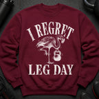 Maroon sweatshirt with distressed graphic of a flamingo lifting a kettlebell and text "I REGRET LEG DAY".