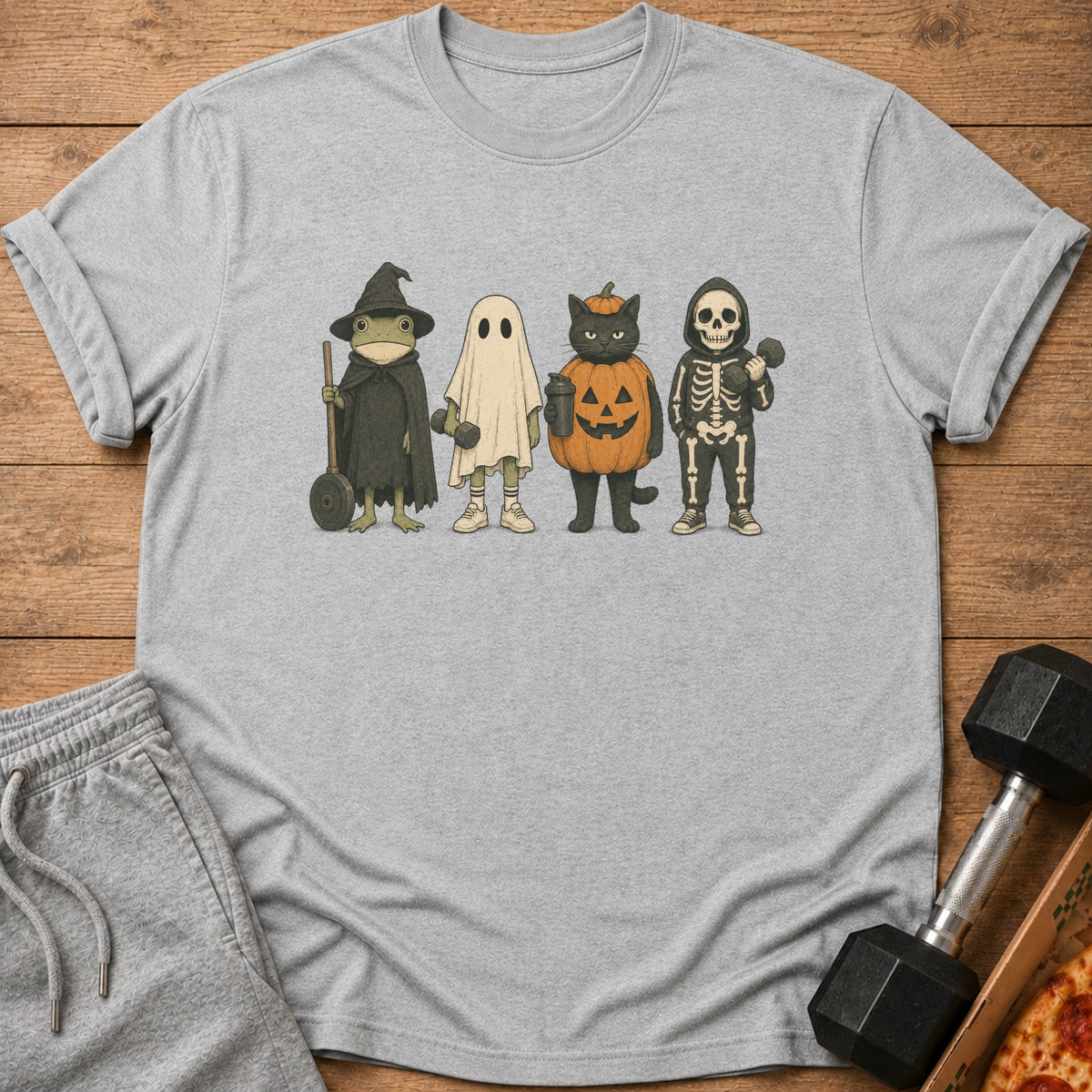 Frog, ghost, cat in pumpkin, and skeleton characters in Halloween costumes on t-shirt.