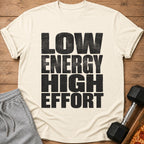 Light cream t-shirt with distressed black text reading "LOW ENERGY HIGH EFFORT".