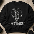 Black sweatshirt featuring a sketched bunny jumping rope with the word OPTIMIST.