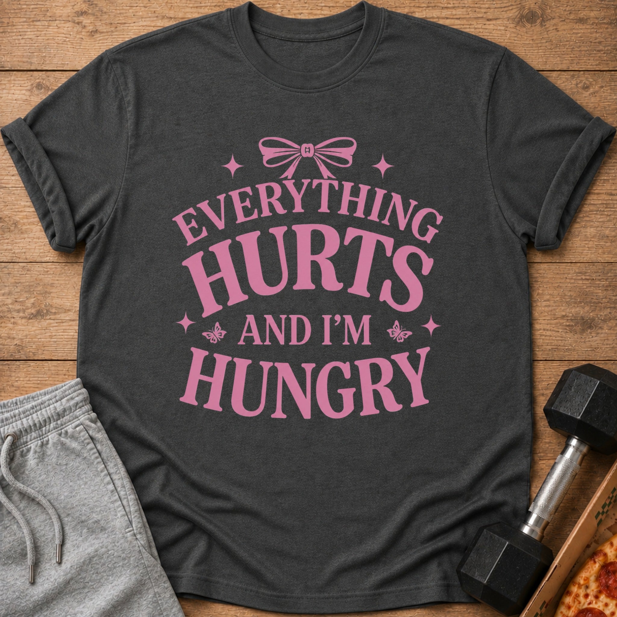 Dark grey t-shirt with pink text "EVERYTHING HURTS AND I'M HUNGRY".